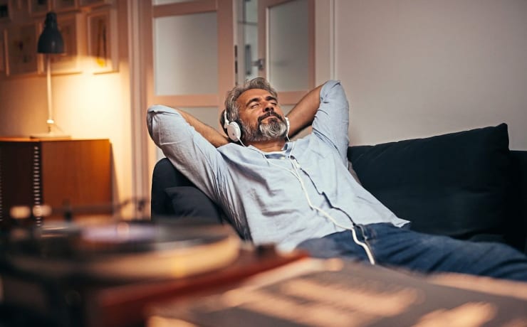 mid aged man listening music with headphones on phonograph, relaxed in sofa at his home; Shutterstock ID 1503129278; purchase_order: Arnaud POURPOINT; job: ; client: ETX Studio / Daily Up; other: